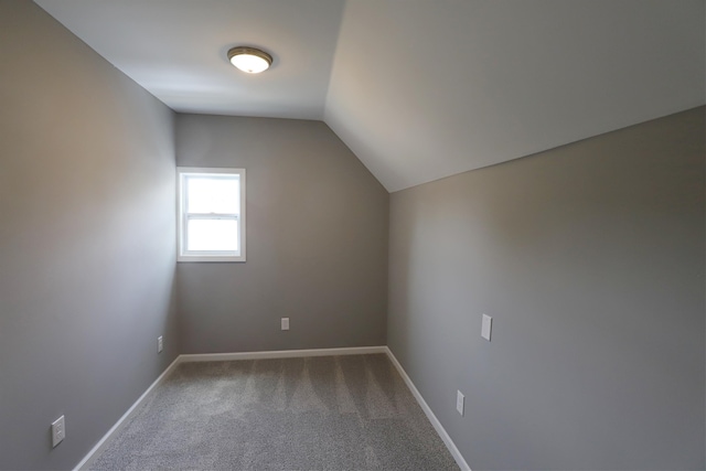 bonus room with carpet floors and vaulted ceiling