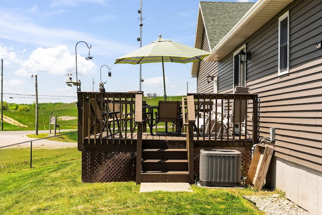 wooden terrace with central air condition unit and a yard