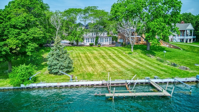 exterior space featuring a yard and a water view