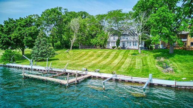 view of dock featuring a yard and a water view