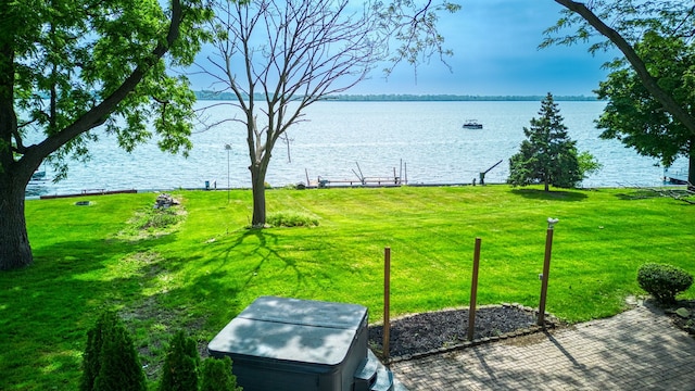 view of yard with a dock and a water view