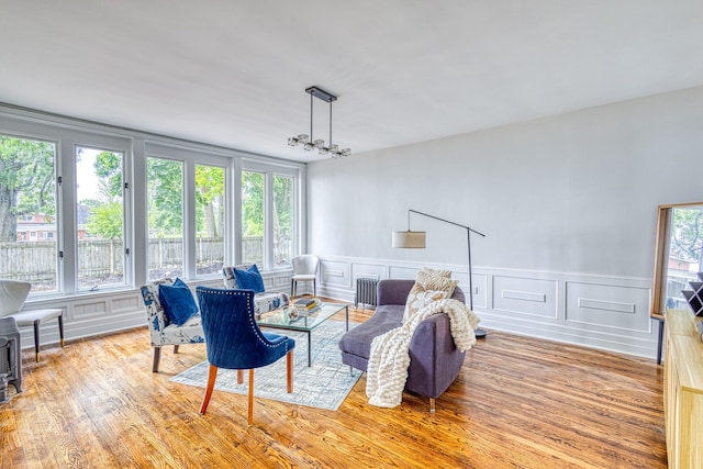 living room featuring a healthy amount of sunlight, light wood-type flooring, and radiator heating unit