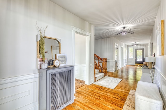 hall with wood-type flooring and french doors