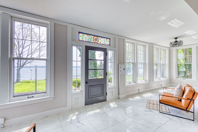 interior space featuring a water view and a healthy amount of sunlight