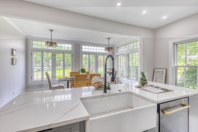 kitchen featuring dishwasher, french doors, pendant lighting, and sink