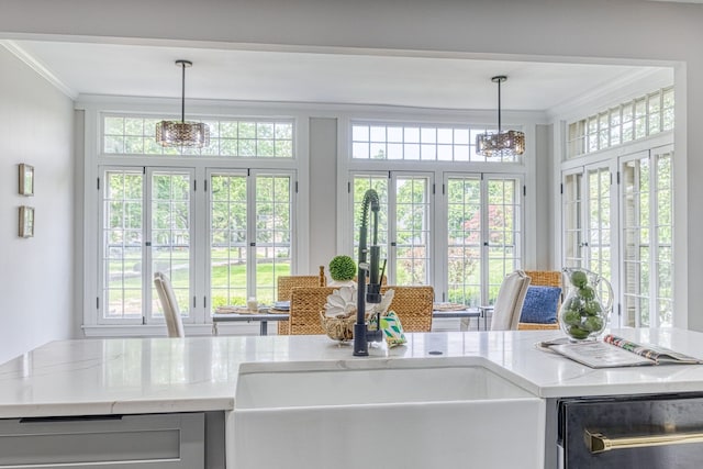 kitchen featuring hanging light fixtures, french doors, a wealth of natural light, and sink