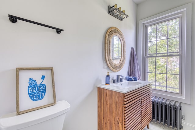 bathroom featuring radiator, vanity, and toilet