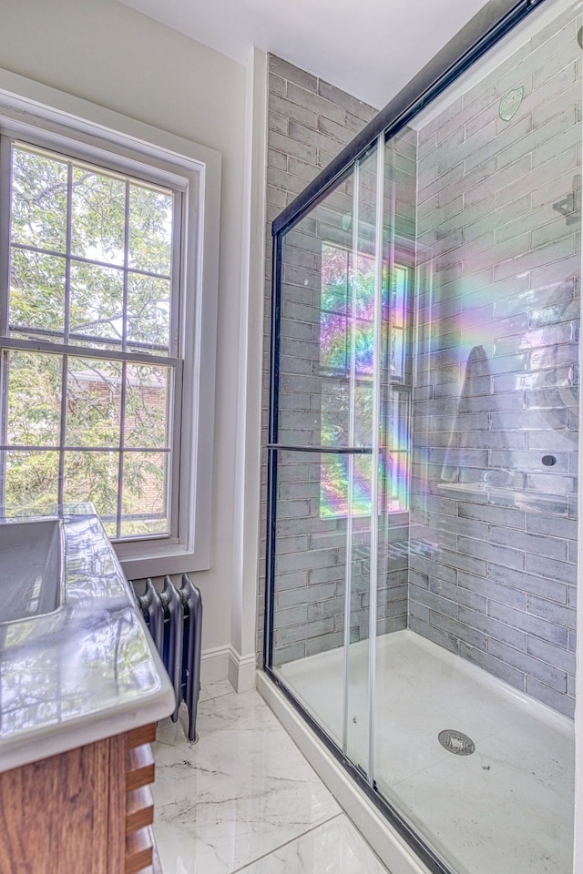 bathroom with radiator and a shower with shower door