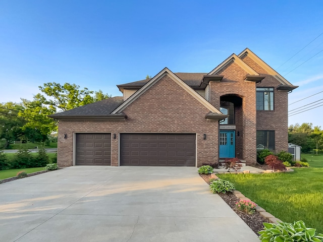 view of front of home featuring a garage and a front lawn