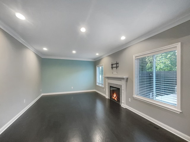 unfurnished living room featuring crown molding and hardwood / wood-style flooring