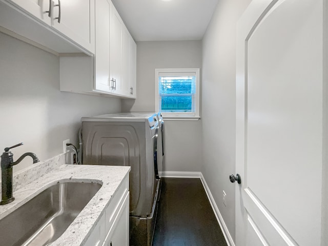 laundry area featuring cabinets, independent washer and dryer, and sink