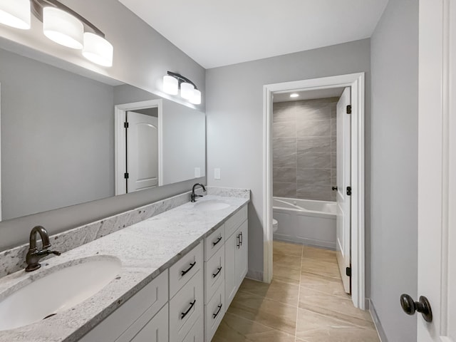 bathroom featuring tile patterned floors, vanity, and toilet