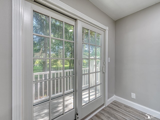 doorway to outside with light wood-type flooring