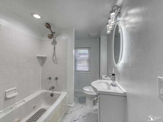 full bathroom featuring vanity, tiled shower / bath combo, and toilet