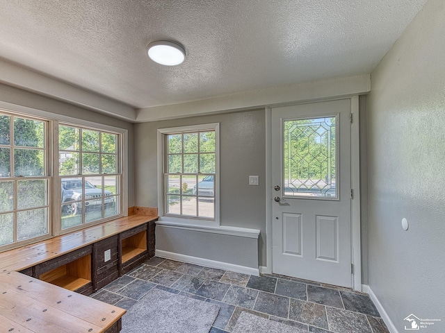 entryway featuring a textured ceiling