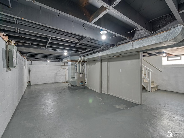 basement with electric panel and heating unit