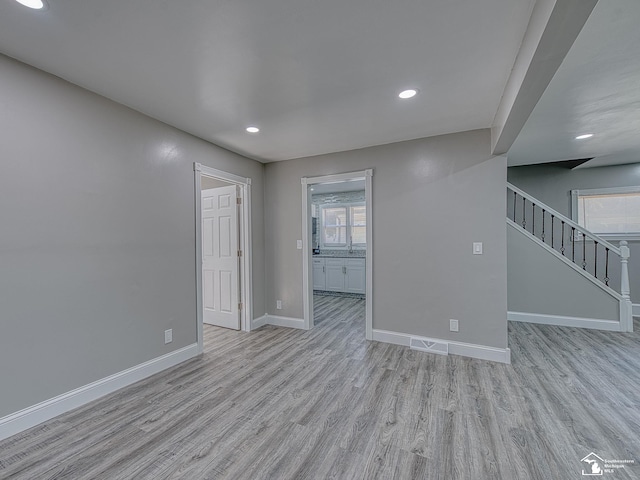 empty room with light hardwood / wood-style flooring