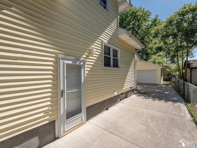 view of property exterior featuring an outbuilding and a garage