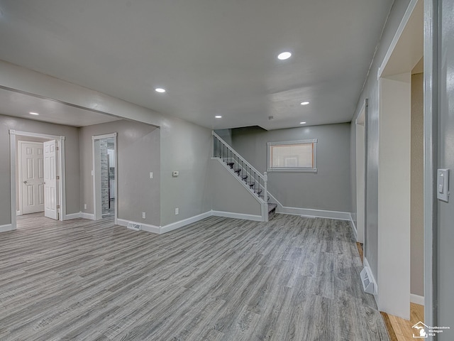 basement with light hardwood / wood-style floors