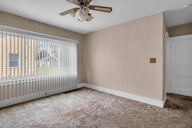 carpeted empty room featuring ceiling fan