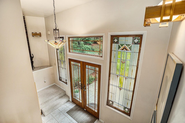6888 Ann Arbor Rd, Jackson, MI 49201 - tiled entrance foyer with french doors, baseboards, and carpet
