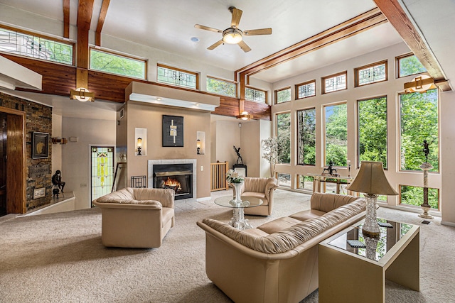 6888 Ann Arbor Rd, Jackson, MI 49201 - carpeted living room featuring a fireplace, a towering ceiling, healthy amount of natural light, and ceiling fan