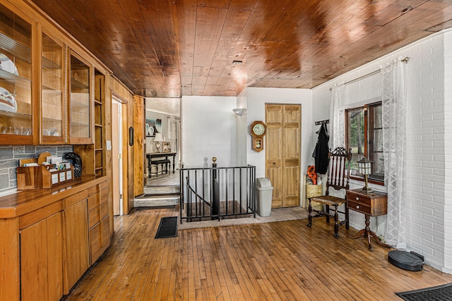 6888 Ann Arbor Rd, Jackson, MI 49201 - entrance foyer with wooden ceiling, hardwood / wood-style flooring, and brick wall