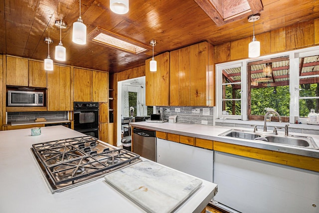 6888 Ann Arbor Rd, Jackson, MI 49201 - kitchen with a skylight, stainless steel appliances, wood ceiling, a sink, and decorative backsplash