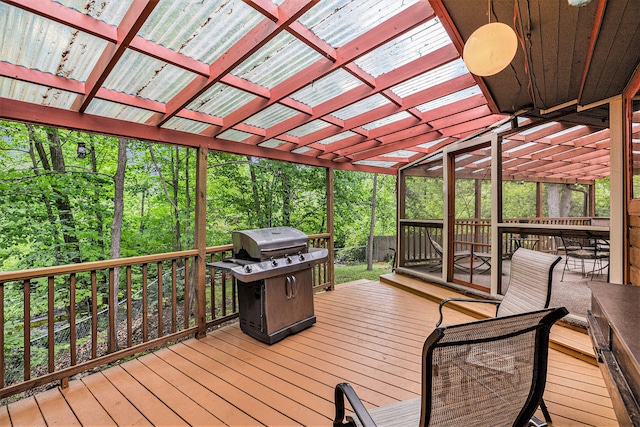 6888 Ann Arbor Rd, Jackson, MI 49201 - wooden terrace featuring grilling area, a pergola, and a forest view