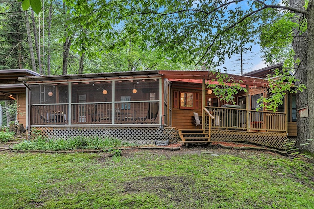 6888 Ann Arbor Rd, Jackson, MI 49201 - view of front of house featuring a sunroom, a wooden deck, and a front yard