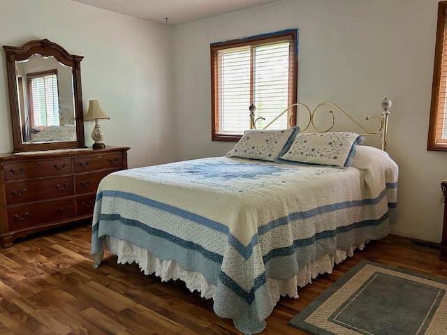 bedroom with dark hardwood / wood-style floors