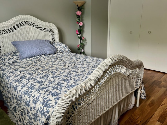 bedroom with dark hardwood / wood-style flooring