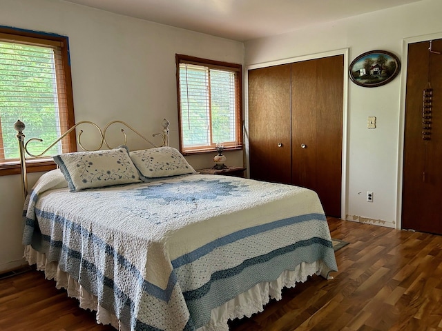 bedroom with a closet and dark hardwood / wood-style flooring