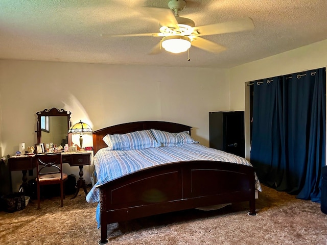 carpeted bedroom featuring ceiling fan and a textured ceiling