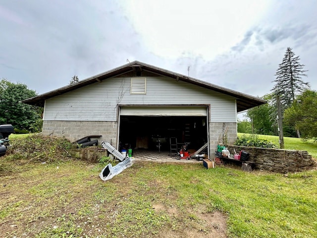 view of home's exterior featuring a garage and an outbuilding