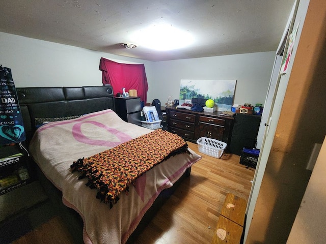 bedroom with hardwood / wood-style floors