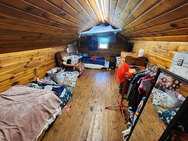 bonus room with hardwood / wood-style floors, vaulted ceiling, and wood walls