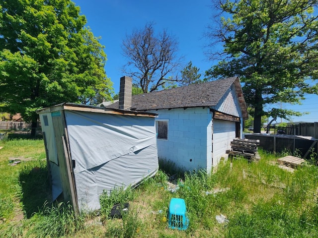 view of side of property with an outbuilding