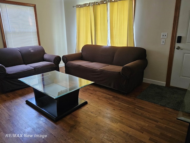 living area with wood finished floors and baseboards