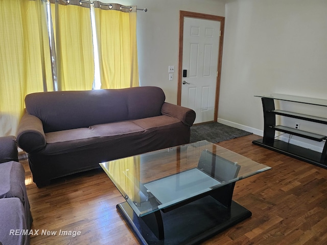 living area with wood finished floors and baseboards