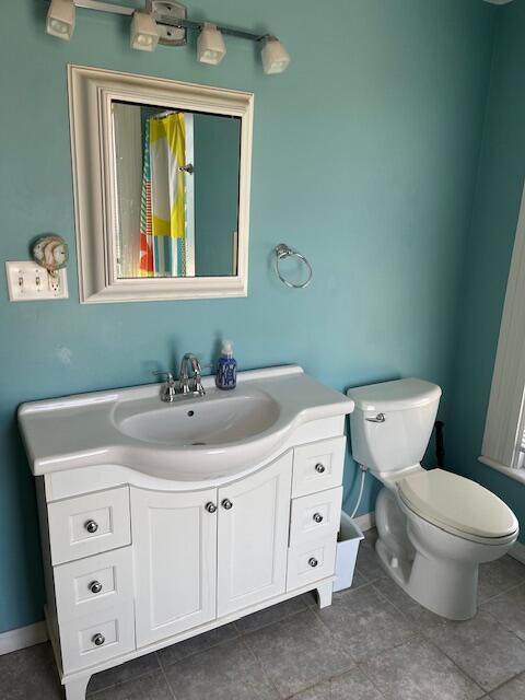 423 Oak St, Paw Paw, MI 49079 - bathroom featuring toilet, vanity, tile patterned floors, and baseboards