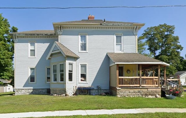 423 Oak St, Paw Paw, MI 49079 - italianate house featuring covered porch, a front lawn, and a chimney
