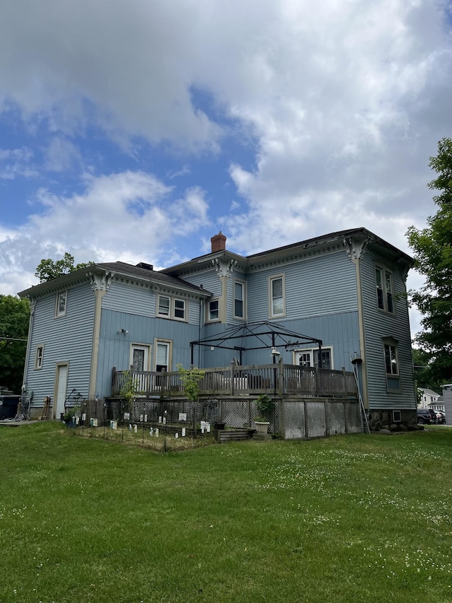 423 Oak St, Paw Paw, MI 49079 - rear view of house featuring a wooden deck, a lawn, and a chimney