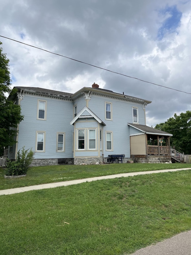 423 Oak St, Paw Paw, MI 49079 - view of property exterior featuring a lawn and a chimney