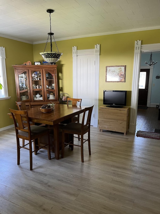 423 Oak St, Paw Paw, MI 49079 - dining area with crown molding, wood finished floors, plenty of natural light, and baseboards