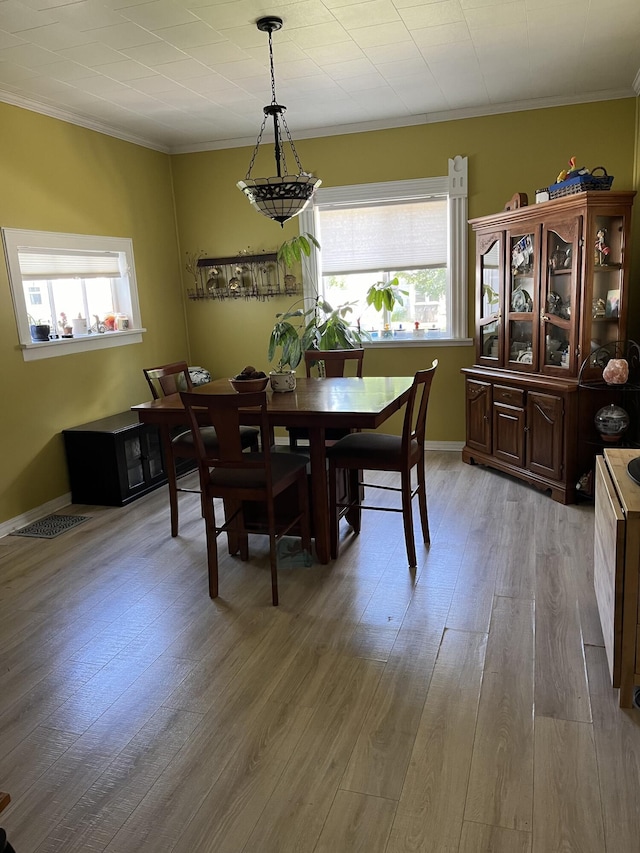423 Oak St, Paw Paw, MI 49079 - dining room featuring crown molding, light wood-style flooring, and baseboards