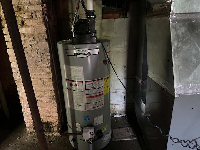 utility room featuring heating unit and water heater