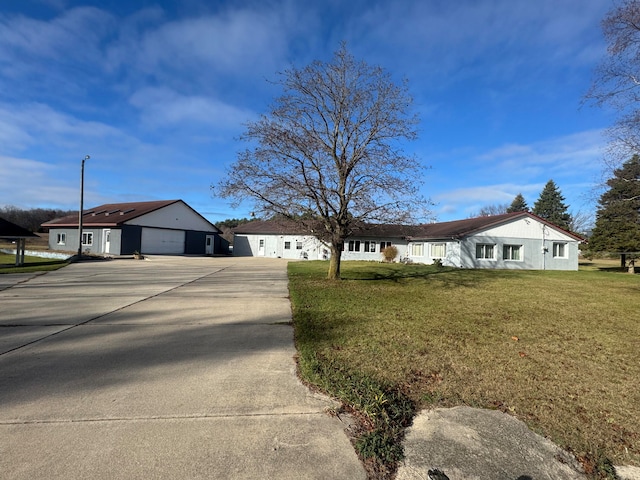 ranch-style house with a garage and a front lawn