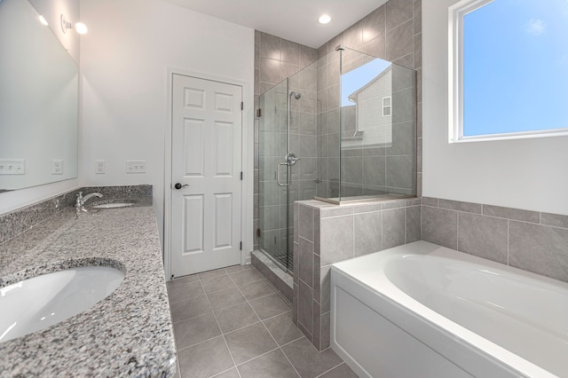 bathroom with tile patterned flooring, vanity, and separate shower and tub