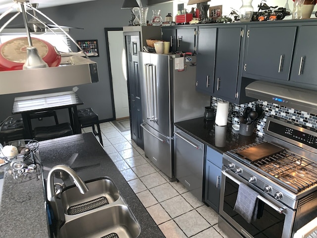 kitchen featuring backsplash, high end appliances, exhaust hood, sink, and light tile patterned floors